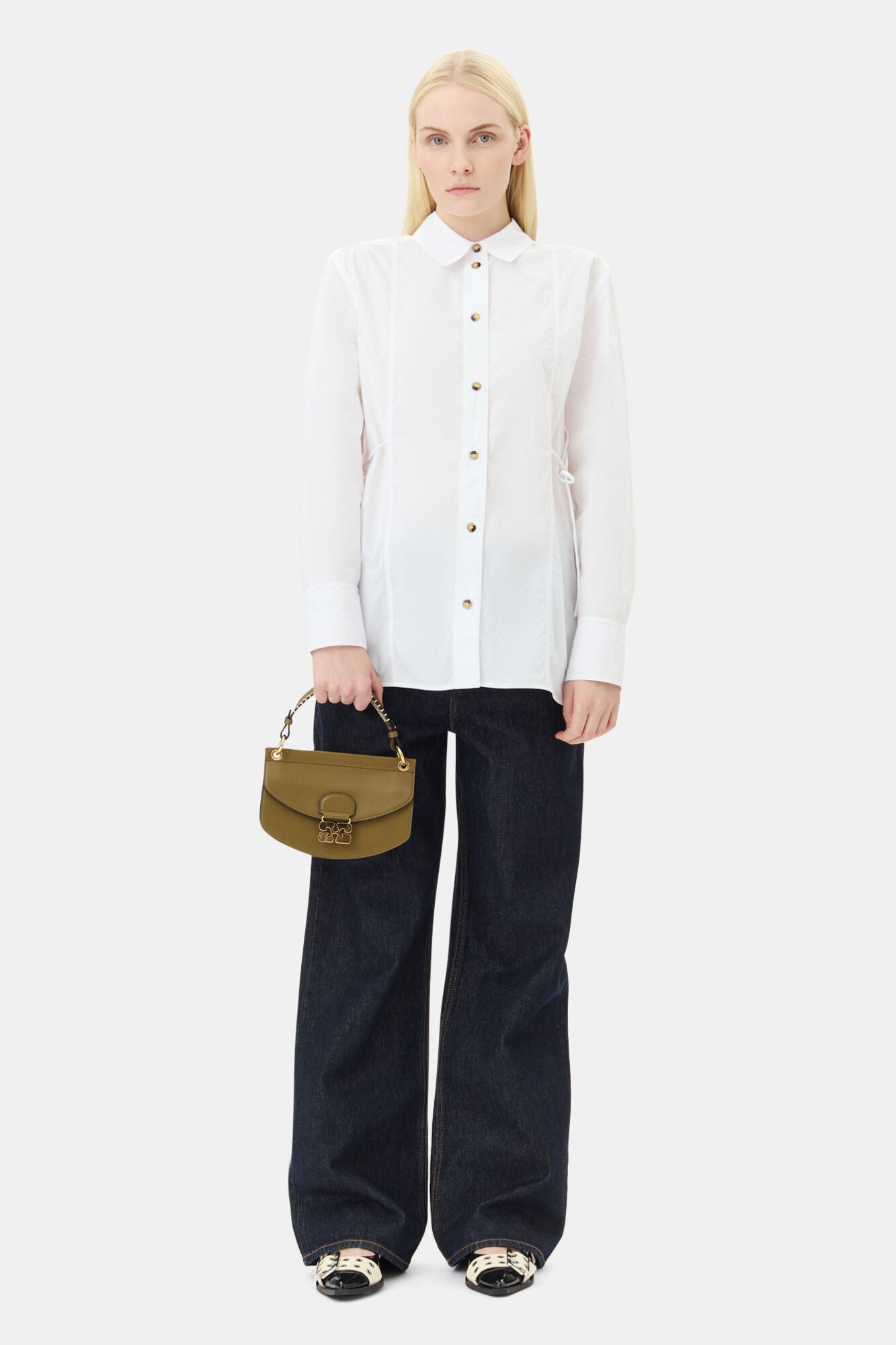 Camisa Ganni branca em popeline com cordões laterais combinada com jeans amplo