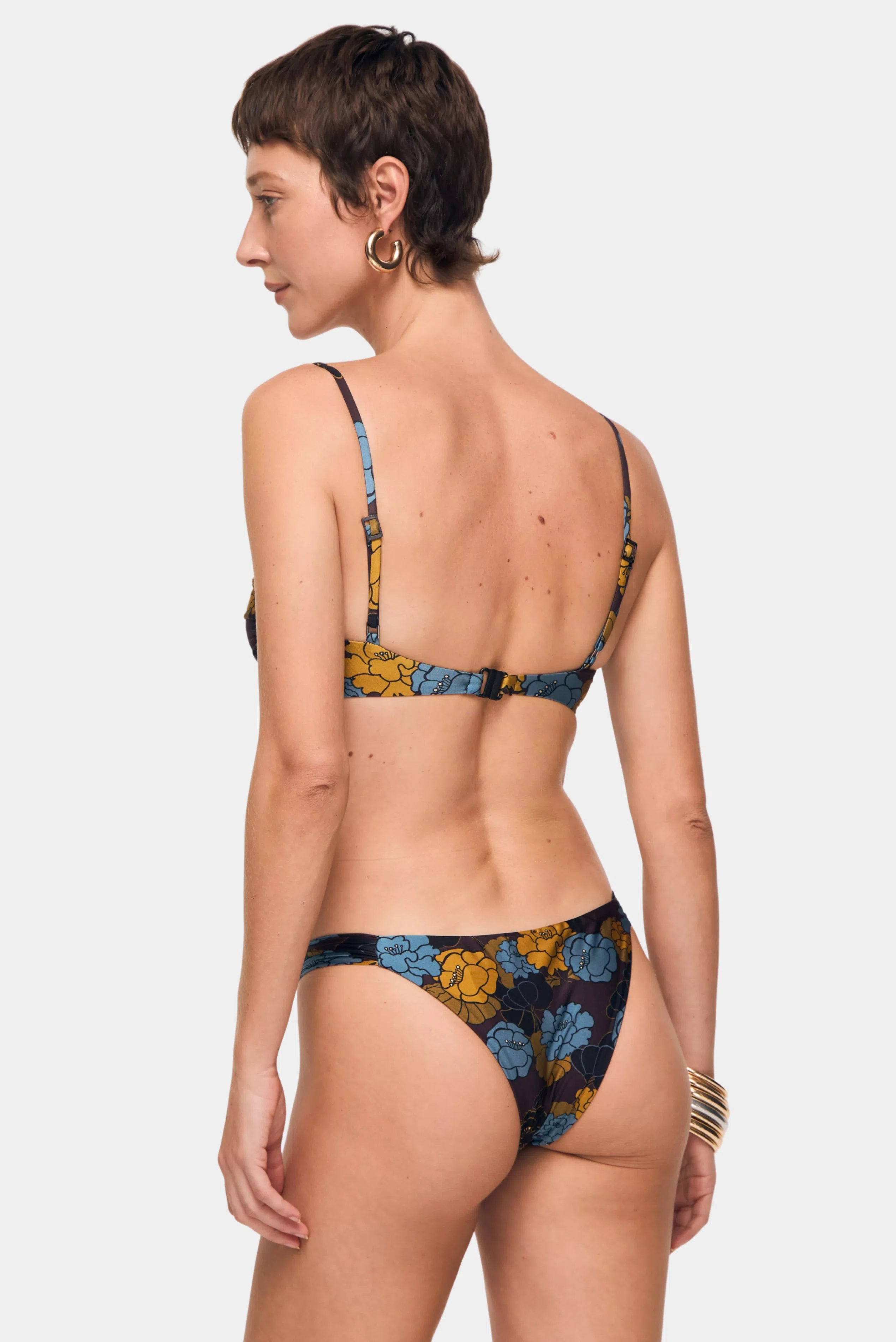 Vista traseira de calcinha de biquíni estampada floral com cobertura média e laterais delicadas