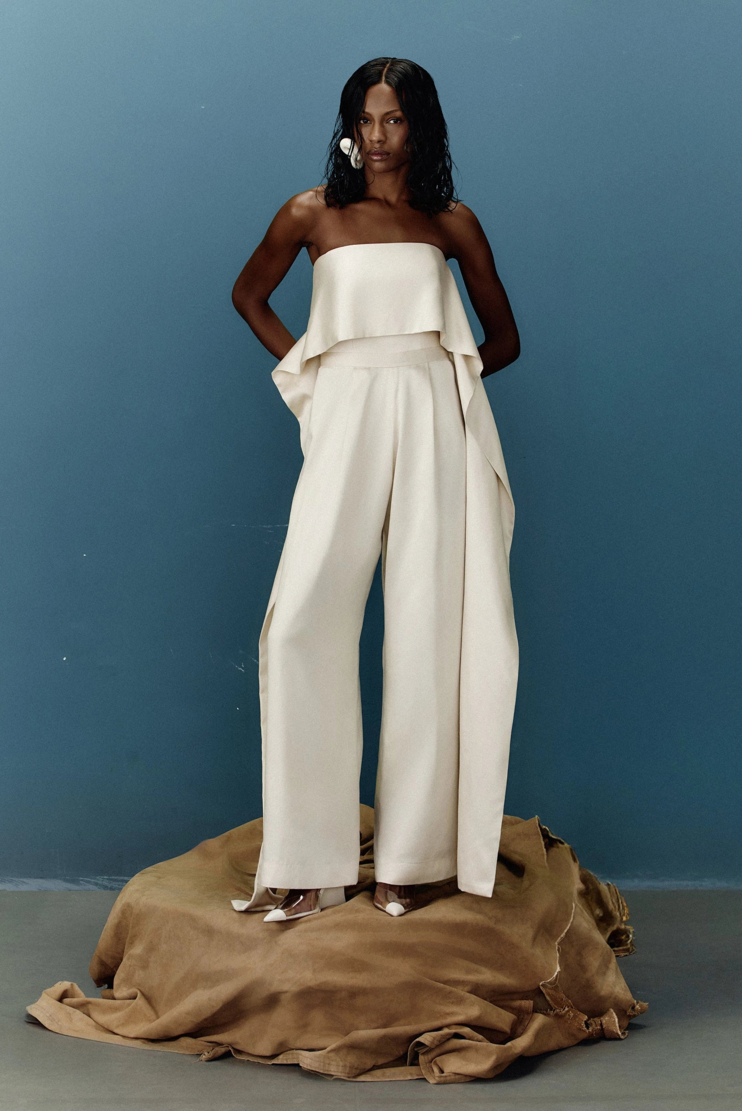 Macacão off-white tomara que caia com sobreposição assimétrica e calça pantalona