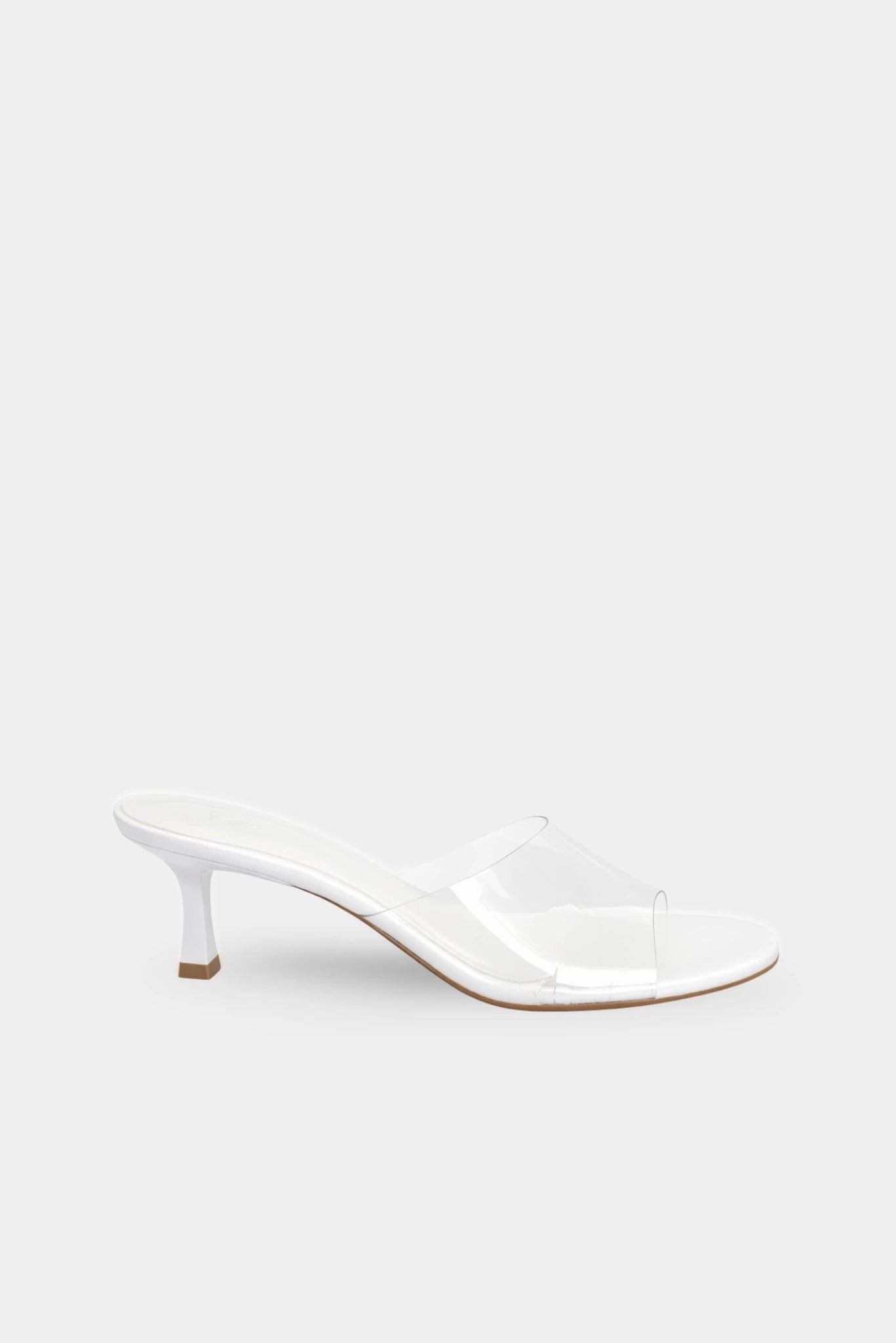 Sandália mule branca com tira transparente e salto médio curvo