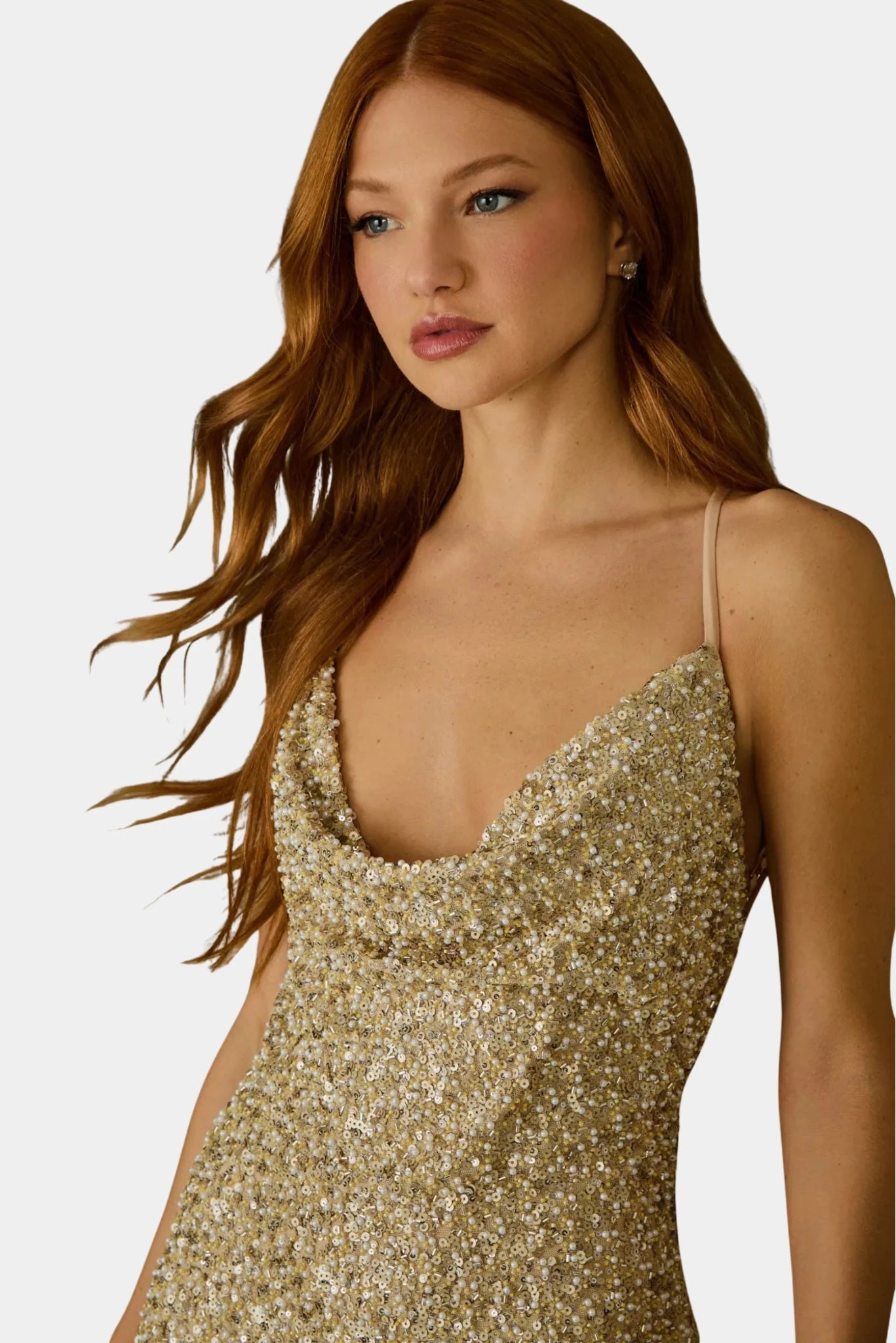 Detalhe de vestido dourado com decote degagê e aplicação de paetês