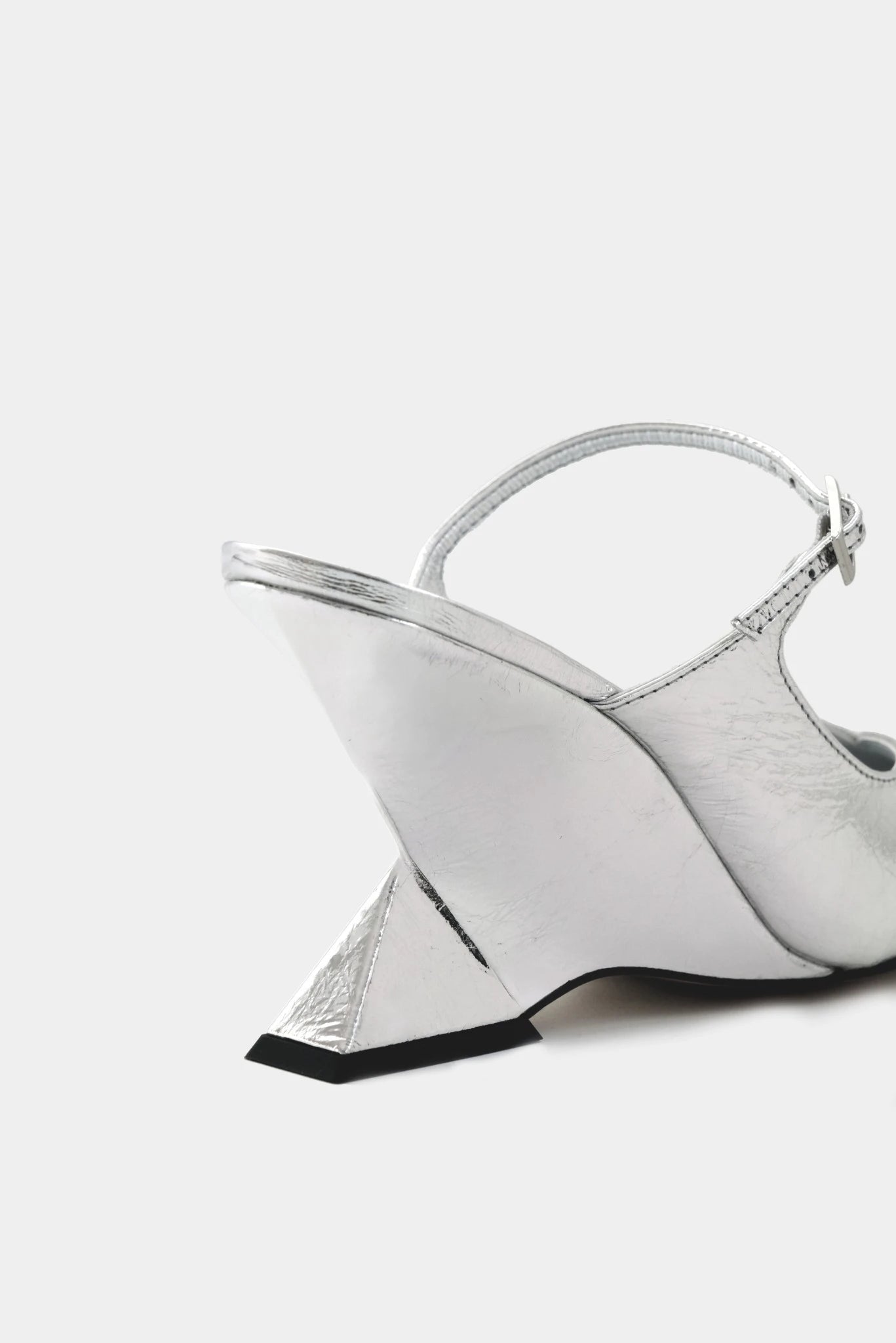 Detalhe do salto geométrico em scarpin slingback prata metalizado