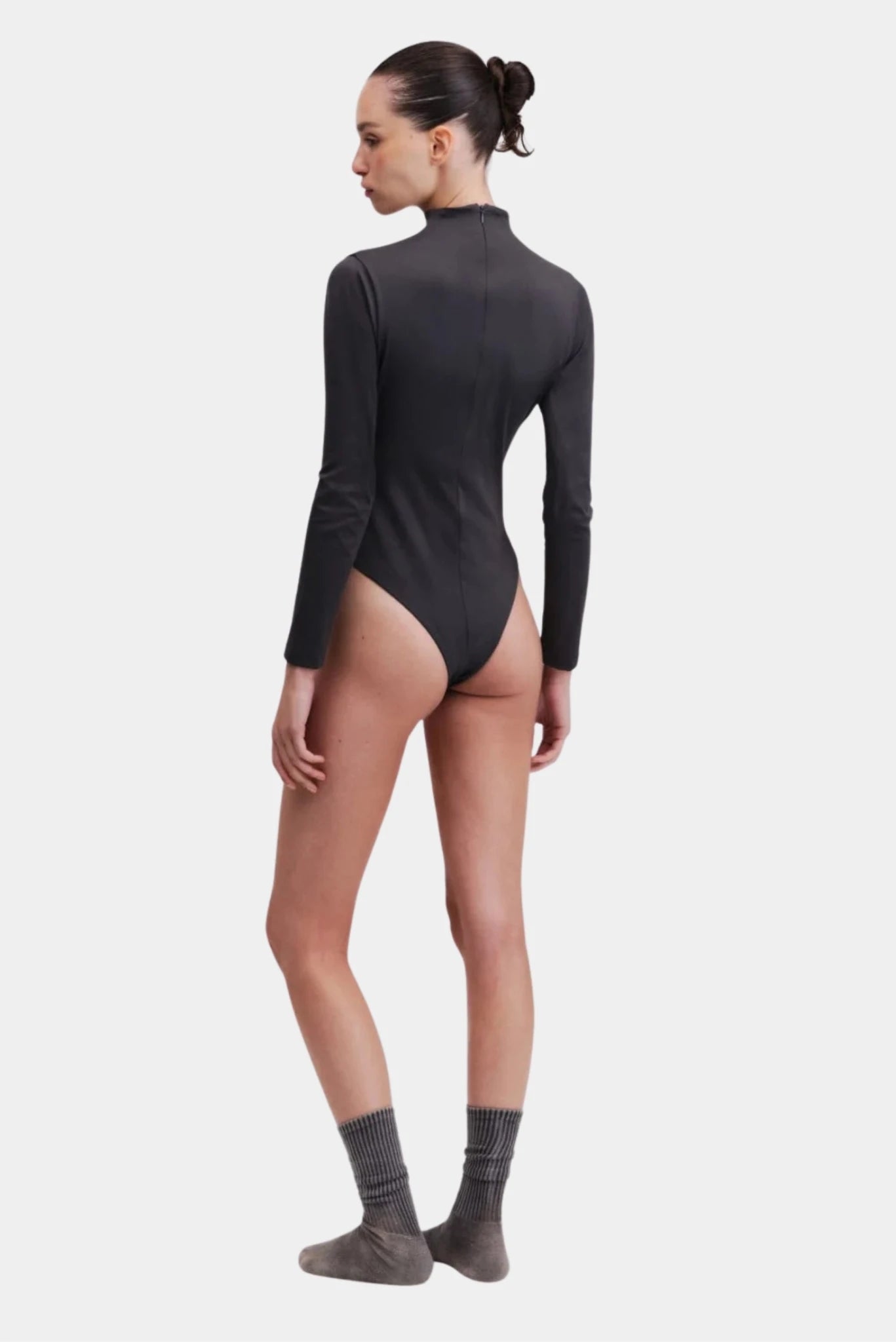 Costas do body preto de manga longa com modelagem ajustada