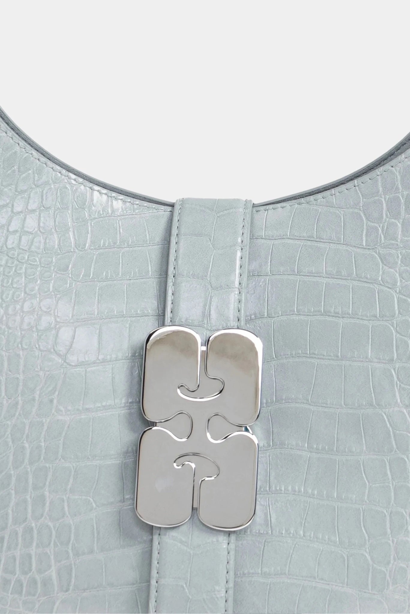 Detalhe do fecho metálico frontal em bolsa Kat pequena croco azul-claro