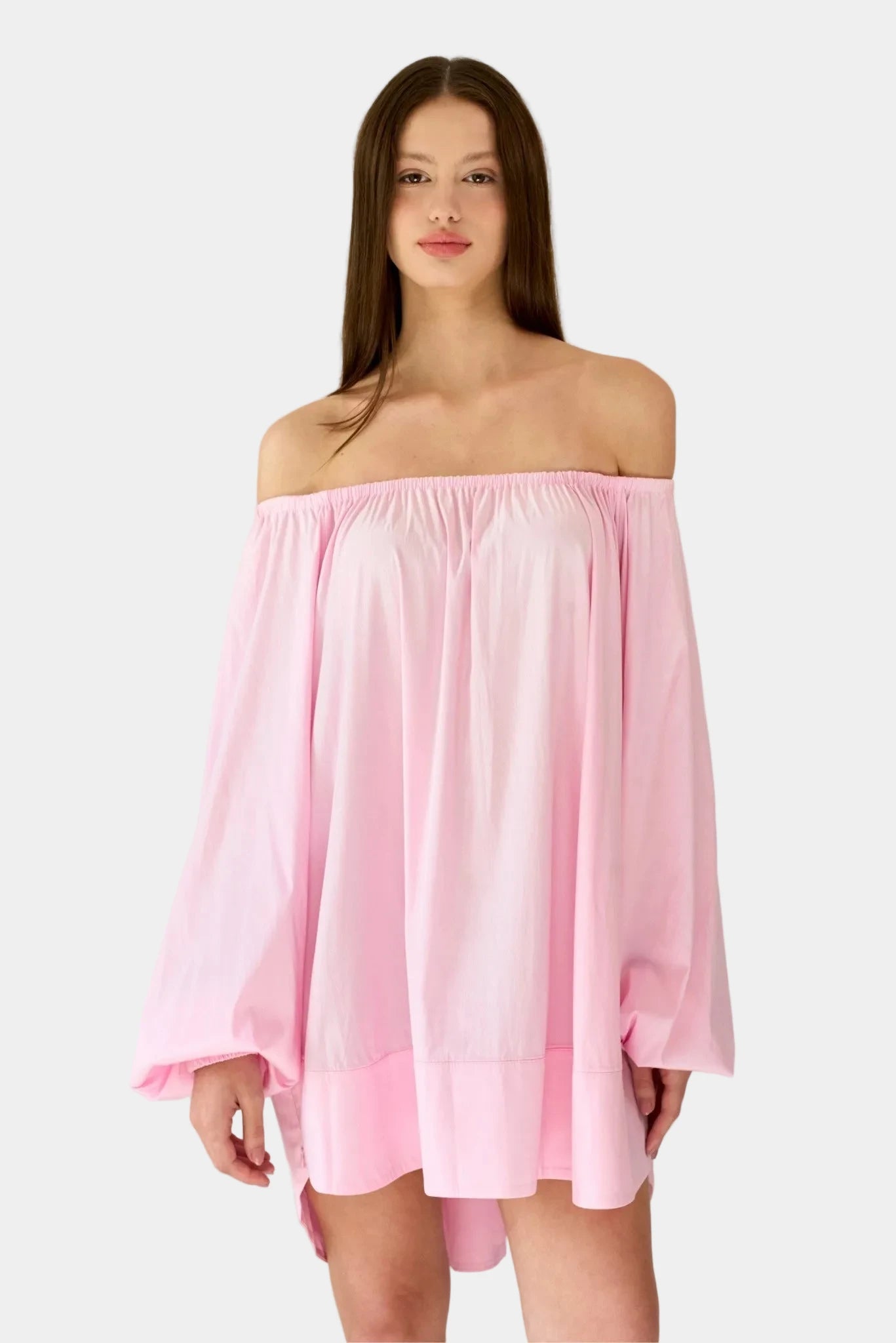 Modelo usando vestido curto rosa ombro a ombro com mangas bufantes amplas